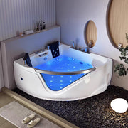 Bồn tắm góc hiện đại với ánh sáng xanh, nền đá cuội, gương tròn và cây xanh trang trí.