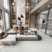 Phòng khách hiện đại, sofa xám, bàn ăn, đèn trần vòng, cửa sổ lớn, kệ sách.