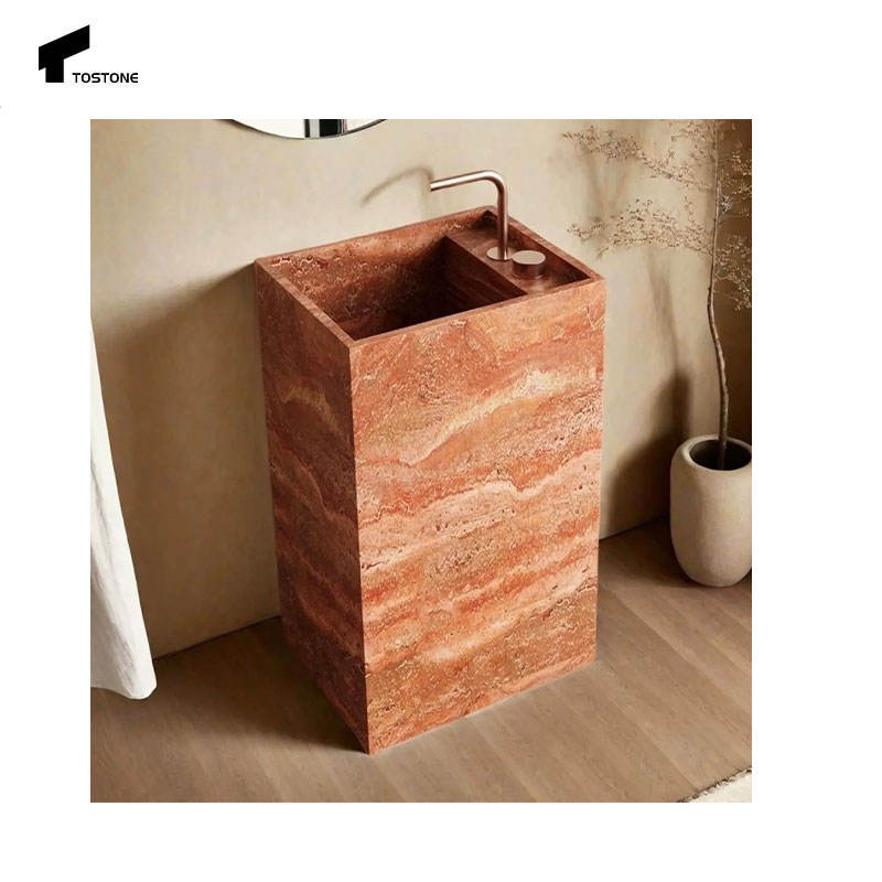 Bồn rửa bằng đá màu cam, vân sóng, vòi kim loại cong, nền tường và sàn màu be.