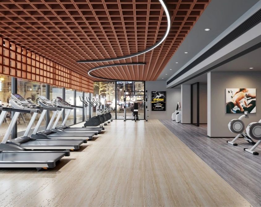 Phòng tập gym hiện đại với máy chạy bộ, mái gỗ, đèn LED uốn cong và sàn gỗ sáng.