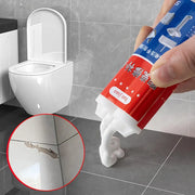 Ống keo đỏ xanh đang được bóp, bên cạnh là bồn cầu trắng và vết nứt gạch được phóng to.